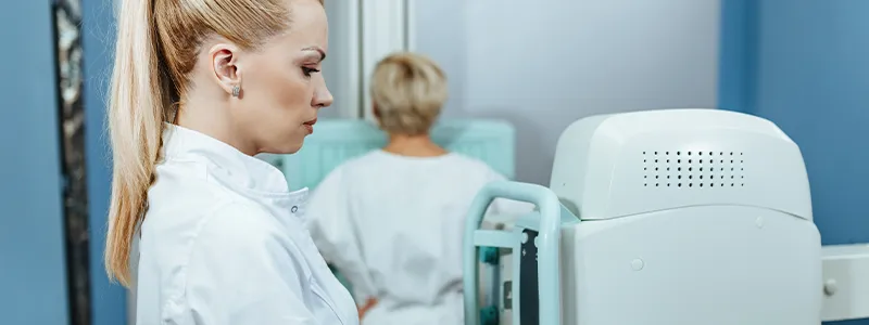 Woman doing a mammogram to detect signs of breast cancer.