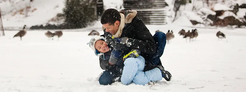 People outdoors enjoying winter, staying warm and healthy.